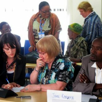 Women in Cities International Director of Programmes Kathryn Travers consults with Huairou Commission Chair of Coordinating Council Jan Peterson at the 2011 Expert Group Meeting on Safe Cities for Girls in Nairobi, Kenya.
